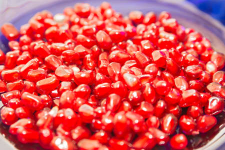 a lot of pomegranate seeds on a plate