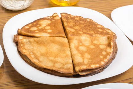 delicious pancakes lie on a white plateの写真素材