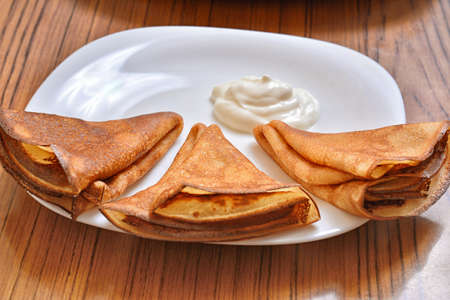 delicious pancakes lie on a white plateの写真素材