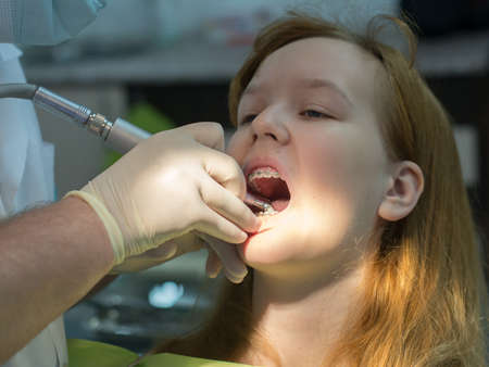girl in the dentist's chair with braces