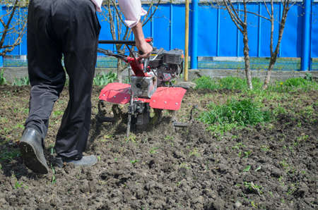 a person cultivates land motor-blockの写真素材