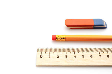 wooden ruler a simple pencil and eraser on a white backgroundの写真素材