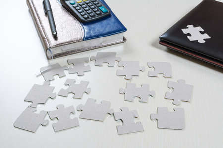puzzle elements are scattered on the desk in the office
