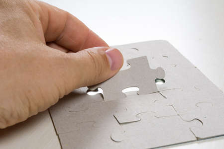 man puts the last element in the puzzle