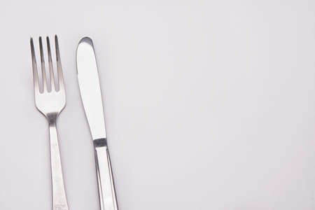 fork and knife on light backgroundの写真素材