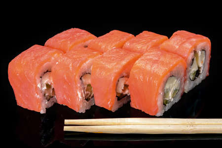 sushi on a black background and chopsticksの写真素材