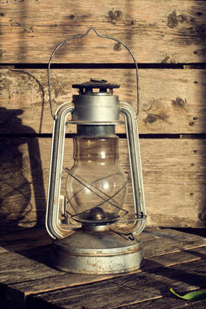 Kerosene lamp and flowers at sunsetの写真素材