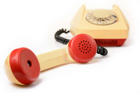 Old disk phone on white with the phone offの写真素材