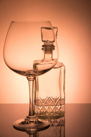 a glass and a decanter on an empty backgroundの写真素材