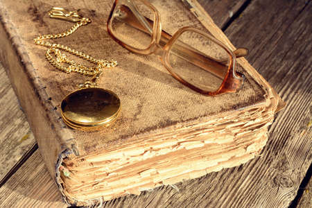 old book glasses and watchesの写真素材