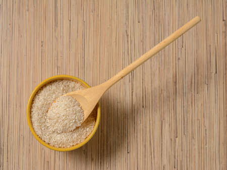 rice in wooden utensils and wooden spoonの写真素材