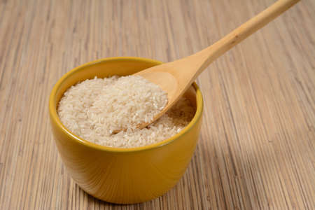 rice in wooden utensils and wooden spoonの写真素材