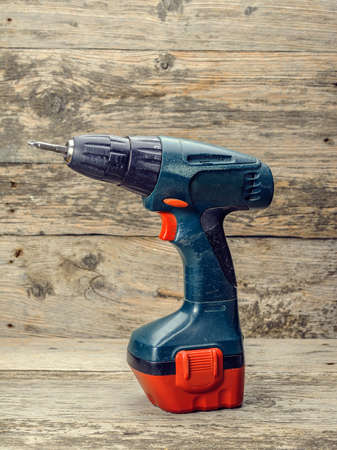 screwdriver drill on a wooden backgroundの写真素材