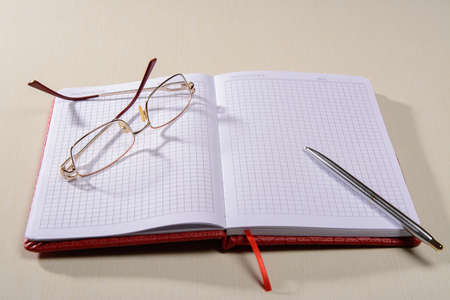 Notepad glasses pen lie on the table