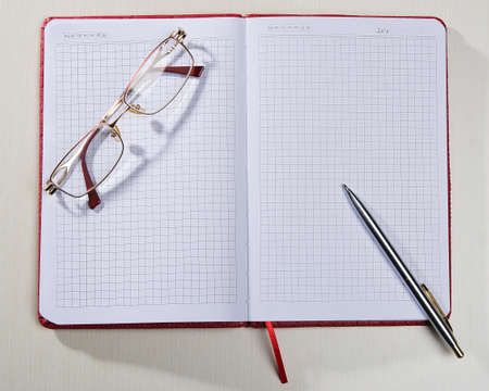Notepad glasses pen lie on the table