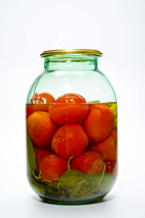 canned tomatoes in a glass jarの写真素材