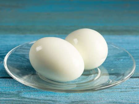 cooked chicken eggs without shell on a plateの写真素材