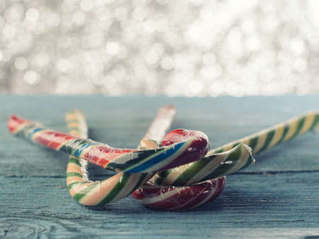 Christmas candy canes of different colors on a beautiful backgroundの写真素材