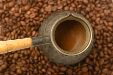 Turk with ready-made coffee on coffee beans