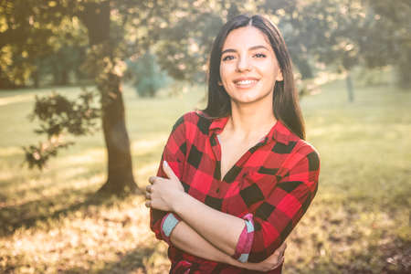 Young female farmer with arms crossed in the fieldの写真素材