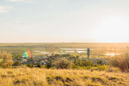 View of countryside at sunset. Autumn is coming. Yellow grass, Blue sky