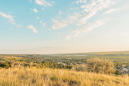 View of countryside at sunset. Autumn is coming. Yellow grass, Blue skyの写真素材