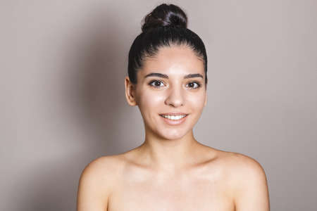 Beauty portrait of a woman with perfect natural skin on neutral backgroundの写真素材