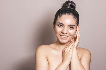 Beauty portrait of a woman with perfect natural skin on neutral backgroundの写真素材