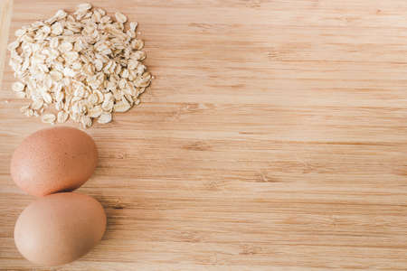 Raw oatmeal with ingredients honey and egg.