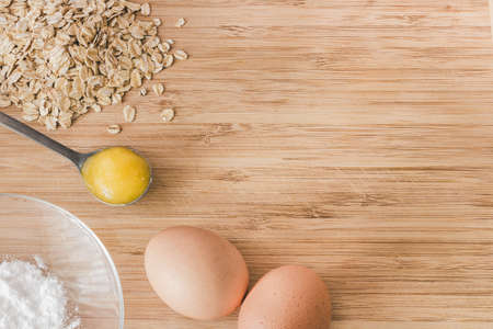 Raw oatmeal with ingredients honey and egg.の写真素材