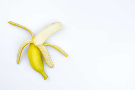 one opened banana on a white background.の写真素材