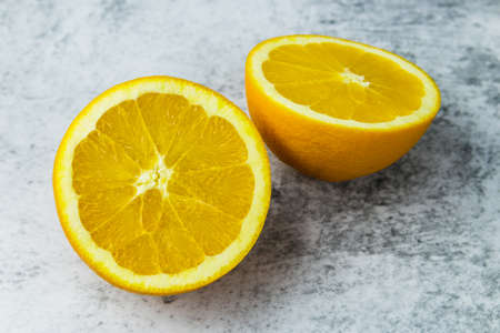 cut oranges on a concrete light background.の写真素材