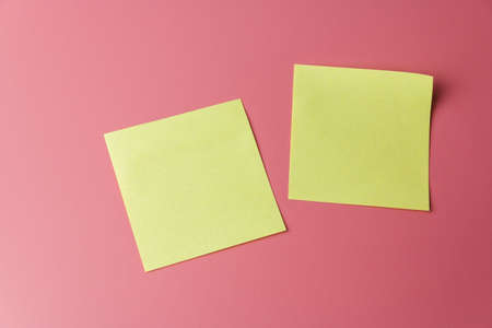 Two yellow sticky note reminders on a red background