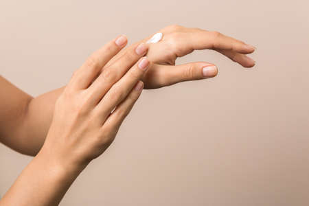 healthy hands of a young woman applying the cream. skincare concept beauty photoshoot.の写真素材
