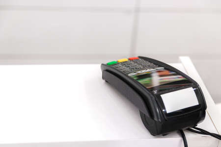wireless payment. credit card terminal on white cashbox