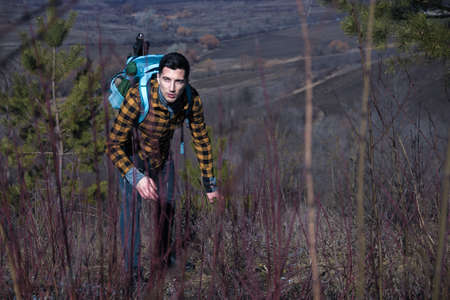 man tourist with fear on face into the wild in the dark. danger in mountains
