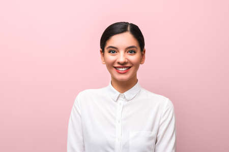young attractive brunette in white shirt with red lips, business makeup and hairs tied against pink...