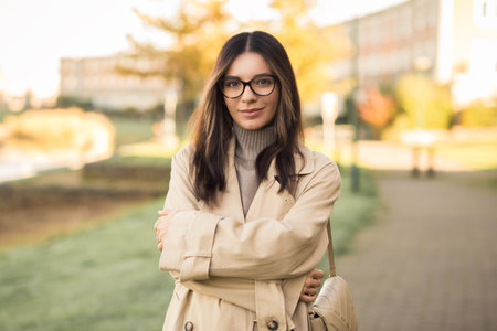 Beautiful LGTB student woman 20s with glasses in the street confidently and profoundly looking towards the cameraの写真素材