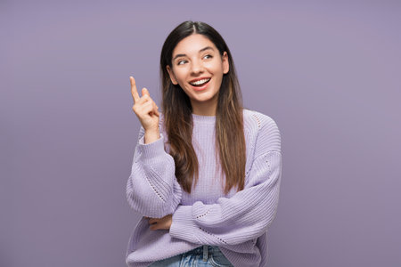 New ideas. Vibrant portrait of multiracial woman pointing finger up and looking away. Solution foundの写真素材