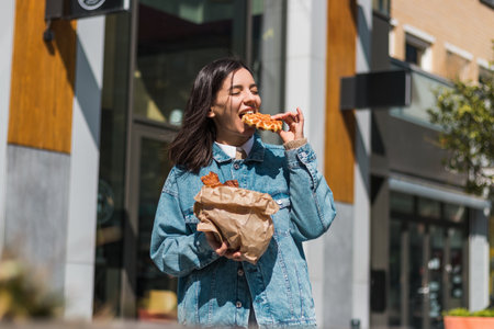 Cool city girl in her element, taking a bite of her favorite pastry while blending foodie flair with...