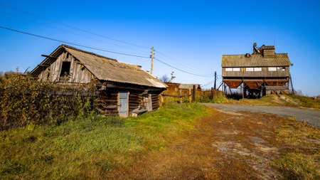 abandoned grain elevator in the farm. old log house in the villageの写真素材