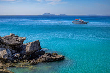 motor yacht in the turquoise sea on the background of rocky Islands. Greece Creteの写真素材