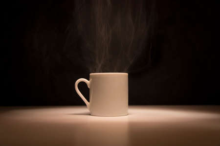 White cup of tea on black backgroundの写真素材