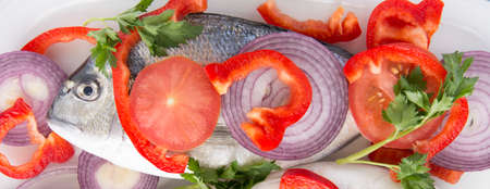 Dorado fish with tropea red onion, tomatoes and pepper mediterranean recipesの写真素材
