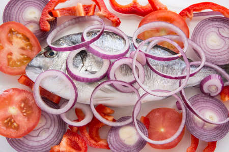 Dorado fish with tropea red onion, tomatoes and pepper mediterranean recipesの写真素材