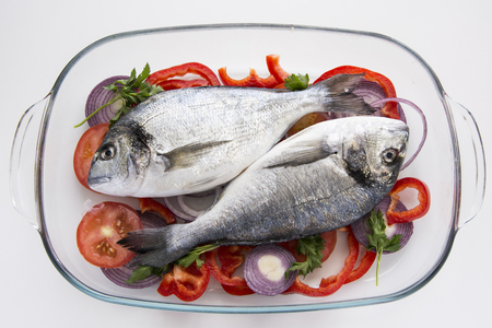 Dorado fish with tropea red onion, tomatoes and pepper mediterranean recipesの写真素材