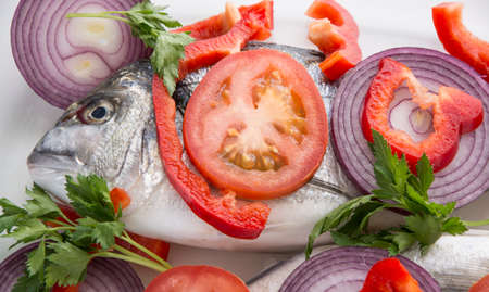 Dorado fish with tropea red onion, tomatoes and pepper mediterranean recipesの写真素材
