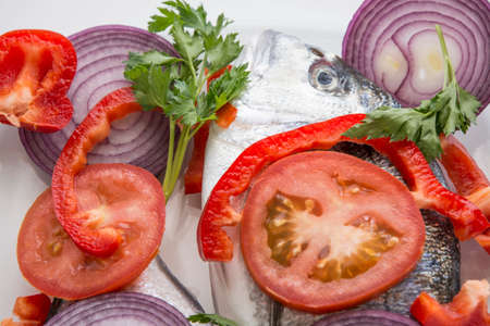Dorado fish with tropea red onion, tomatoes and pepper mediterranean recipesの写真素材