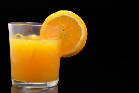 Orange juice on black background, healthy drinkの写真素材