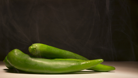 Roasting hot green peppers, cooking peppers, spicy foodの写真素材